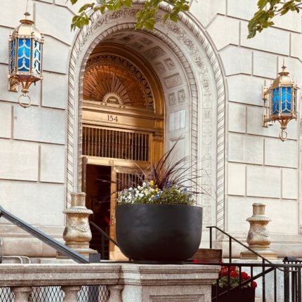 Elegant entrance to 154 building, showcasing classic Boston architecture with decorative elements.