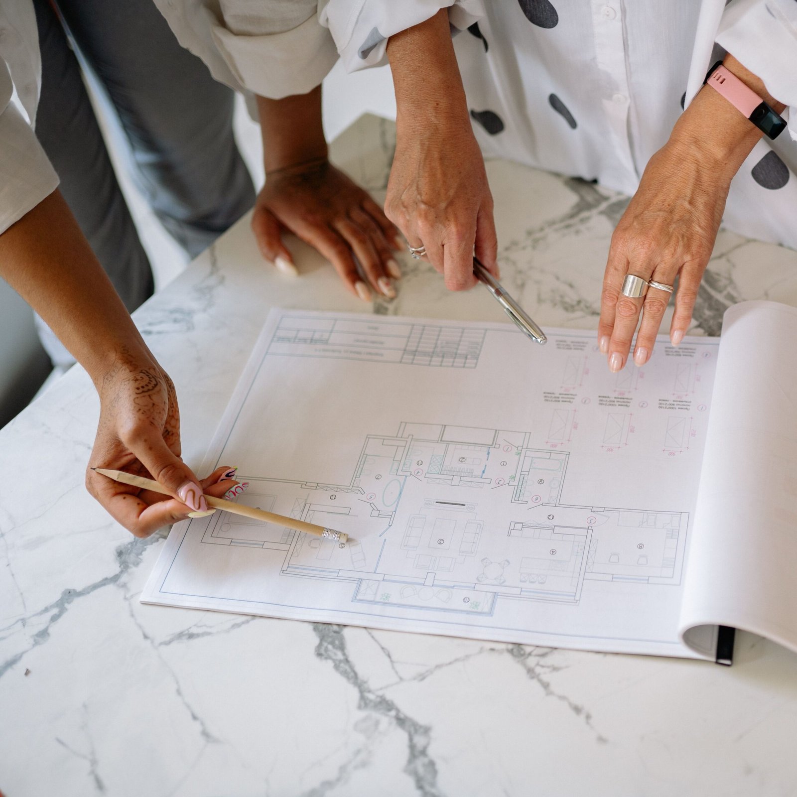 pexels-photo-8837715-8837715-1 Women collaborating on architectural plans, emphasizing teamwork and precision.